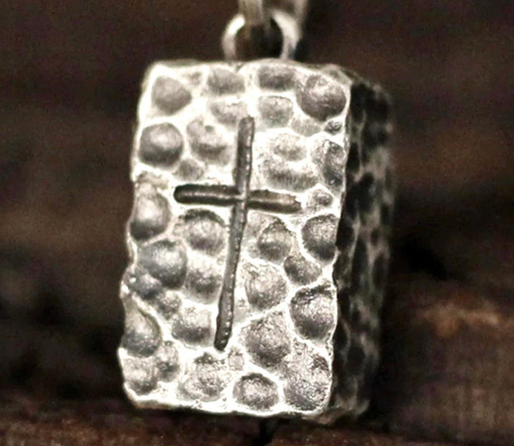 Hammered stainless steel rectangle cross pendant, close-up of hammered texture