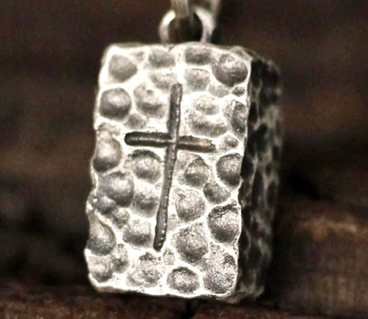 Hammered stainless steel rectangle cross pendant, close-up of hammered texture