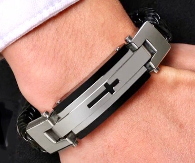 Stainless steel bracelet with black leather braid and raised cross detail on front plate