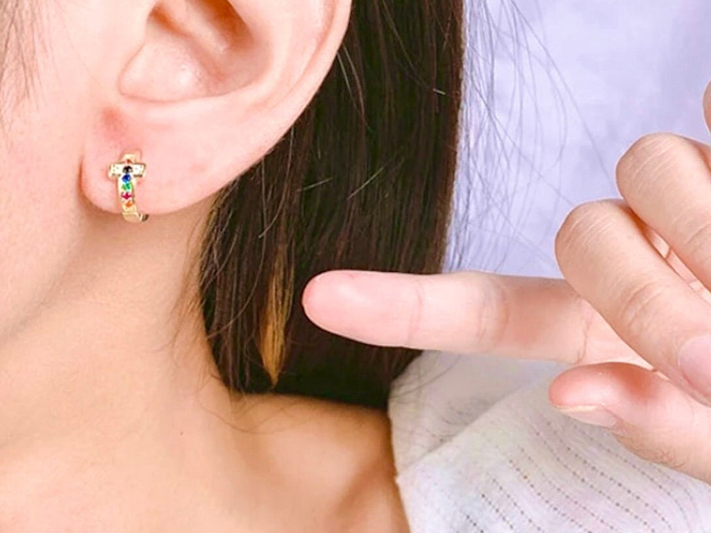 Gold small cuff earrings with rainbow CZ stones on a hinged hoop