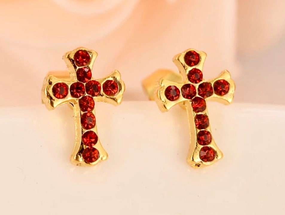 Gold cross stud earrings with red round CZ stones, centered view of both earrings