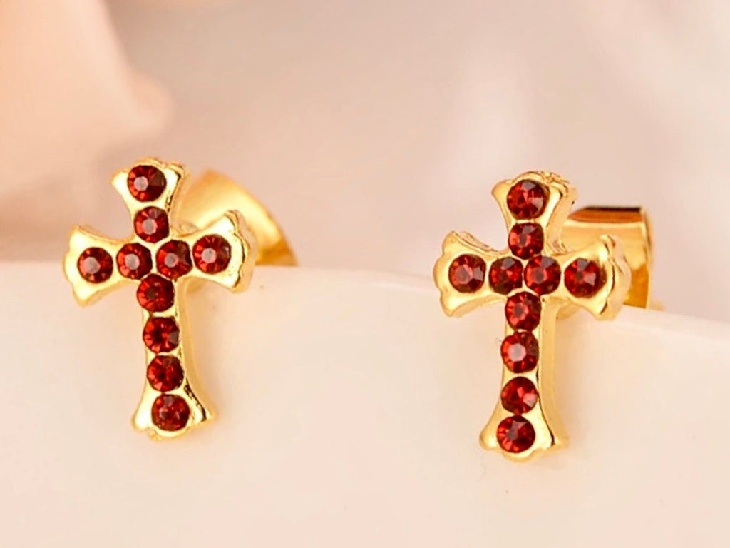 Pair of gold cross stud earrings with red round CZ stones, close-up view