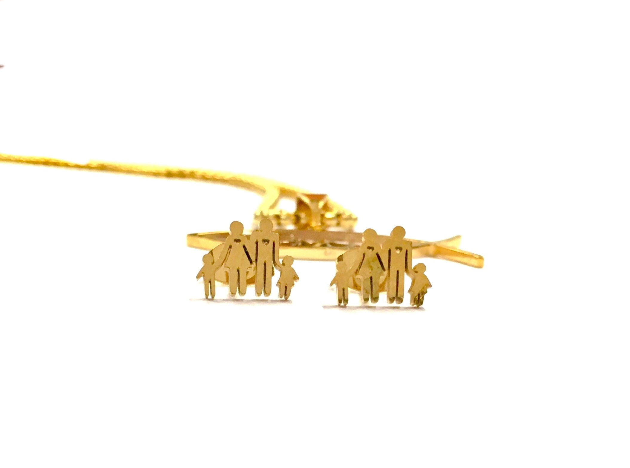 Gold-tone family fish motif stud earrings, side view