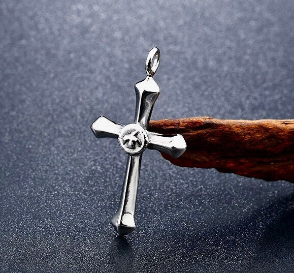Silver-tone cross pendant with circular emblem, on chain