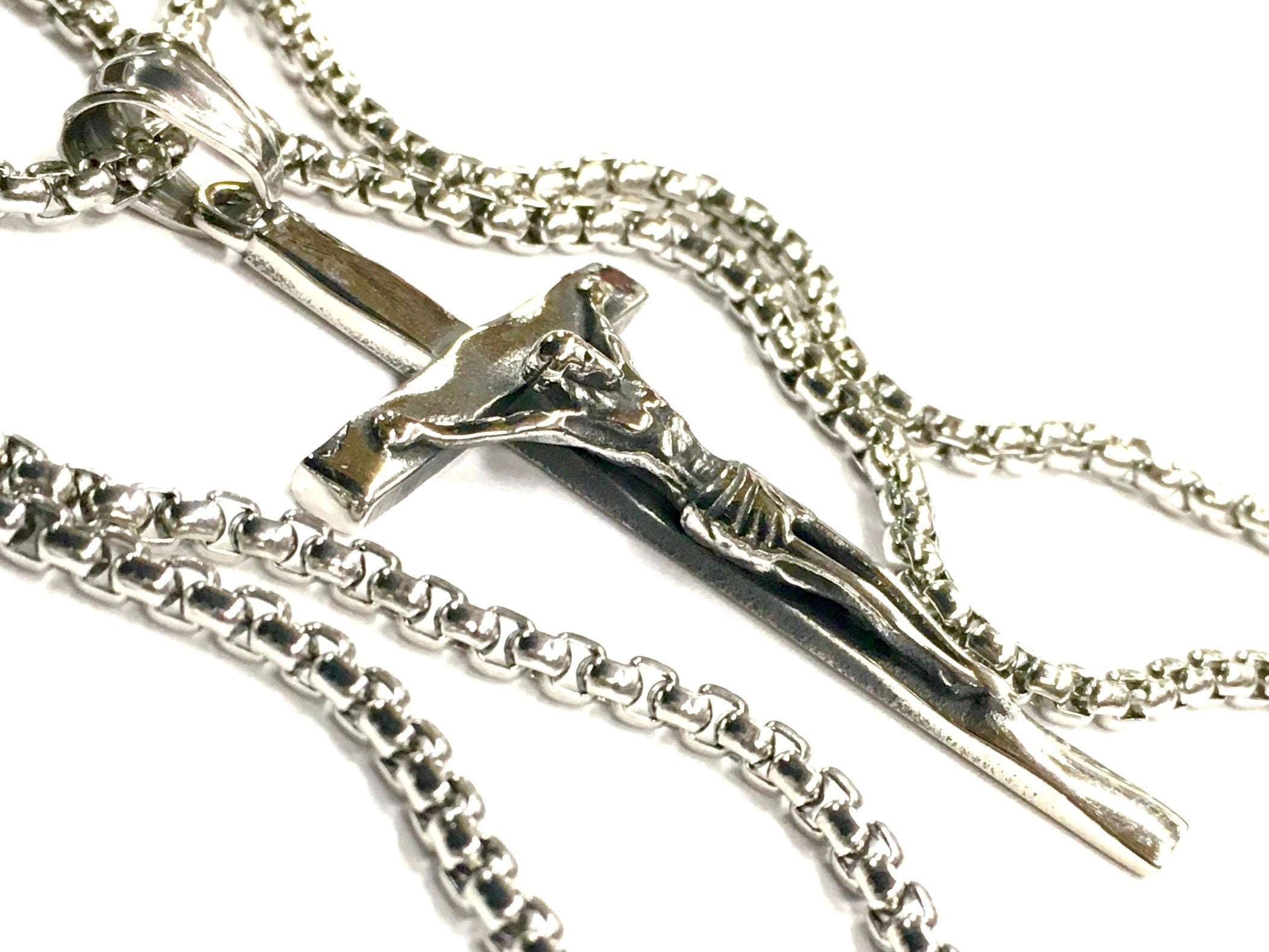 Stainless steel crucifix pendant with link chain, side view of Jesus relief.