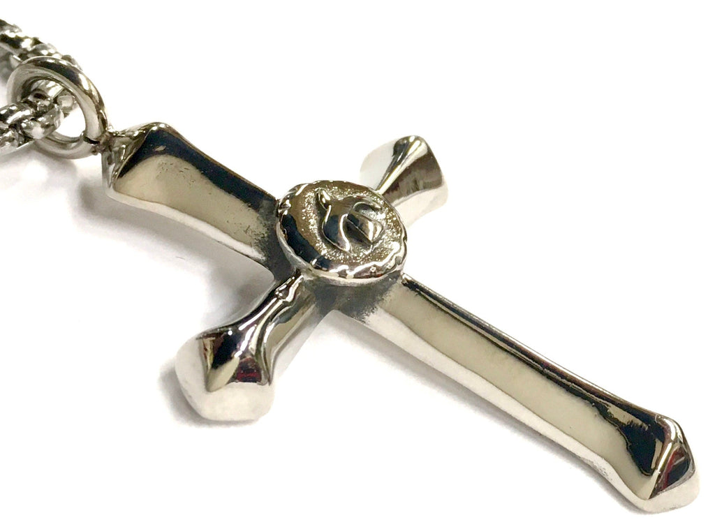 Silver-tone cross pendant with circular center detail and chain