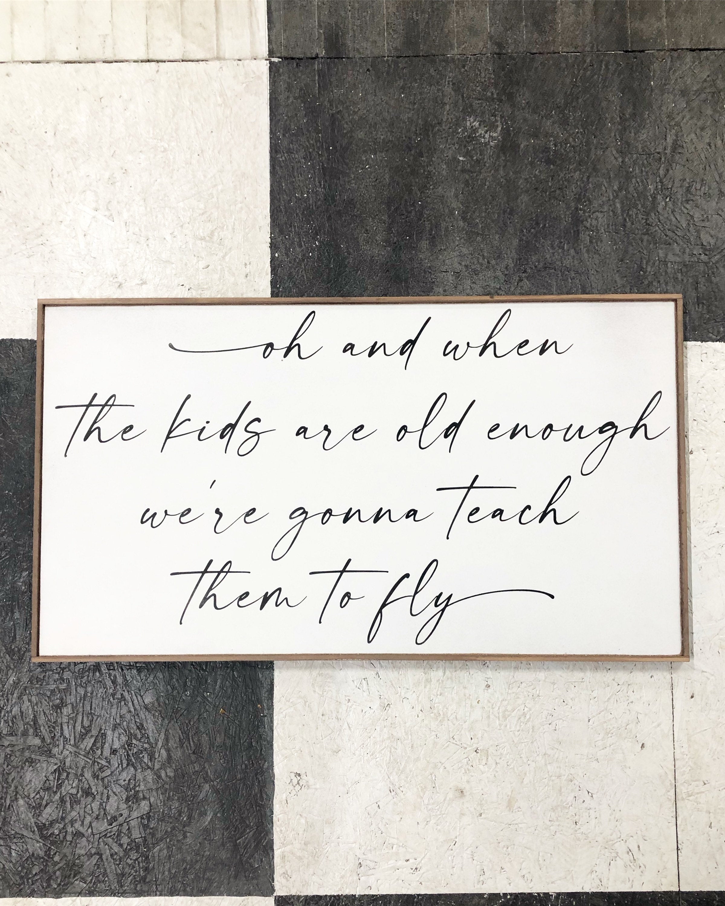 Framed wooden wall sign with white panel and black cursive quote, “oh and when”