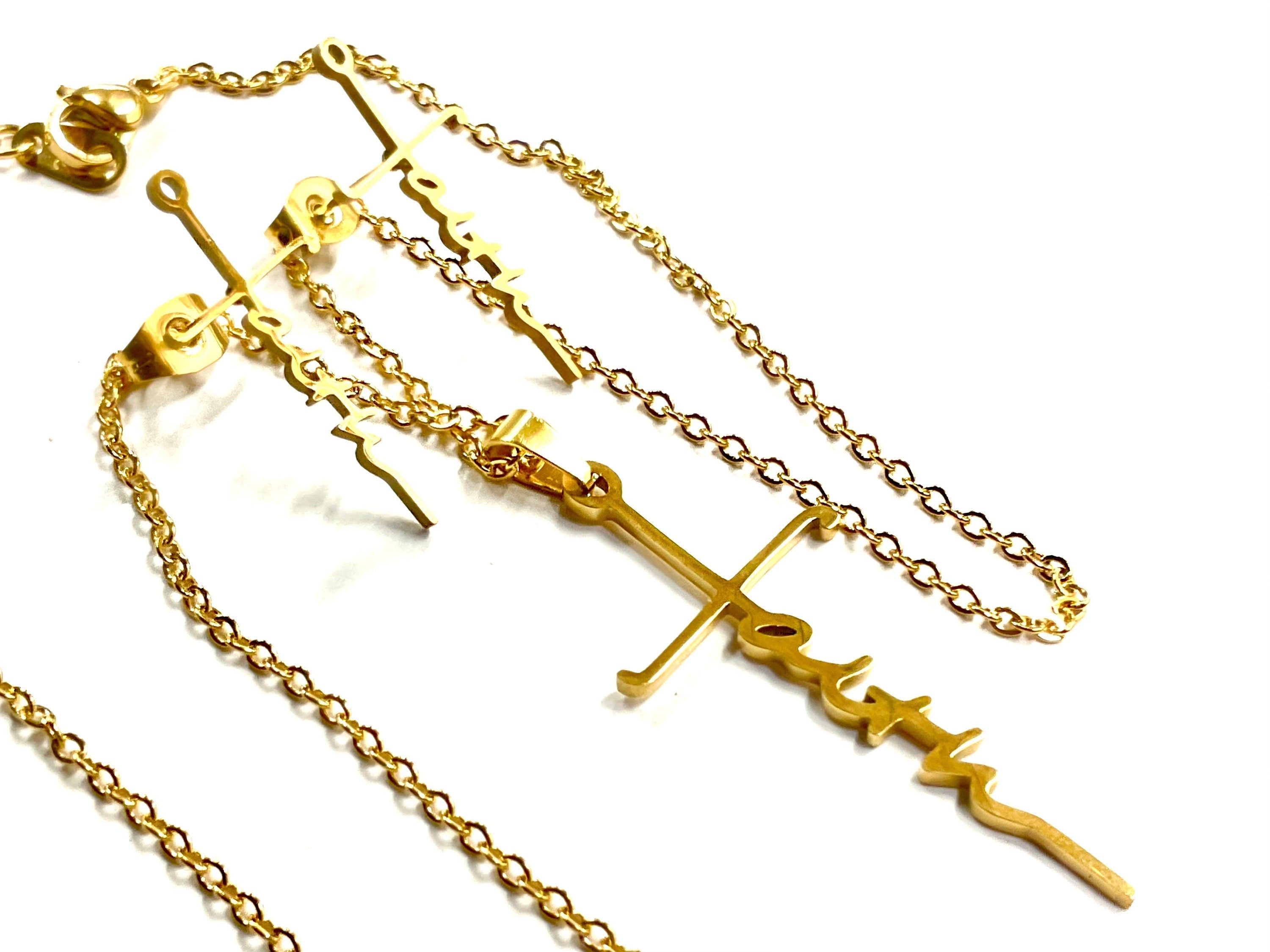 Gold cross pendant necklace with dangling cross-and-script earrings