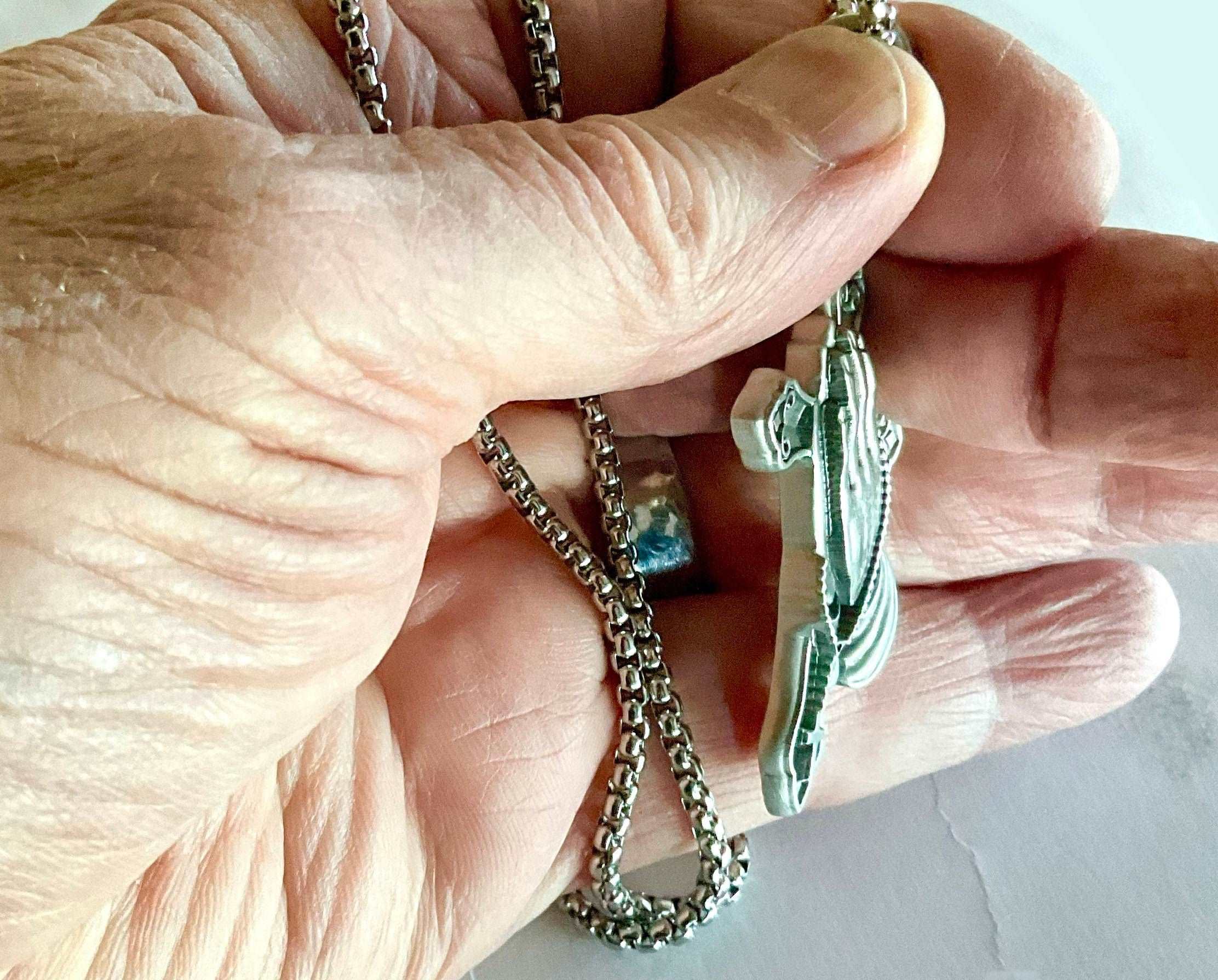 Silver rosary necklace with thick chain and teal-inlay praying hands crucifix