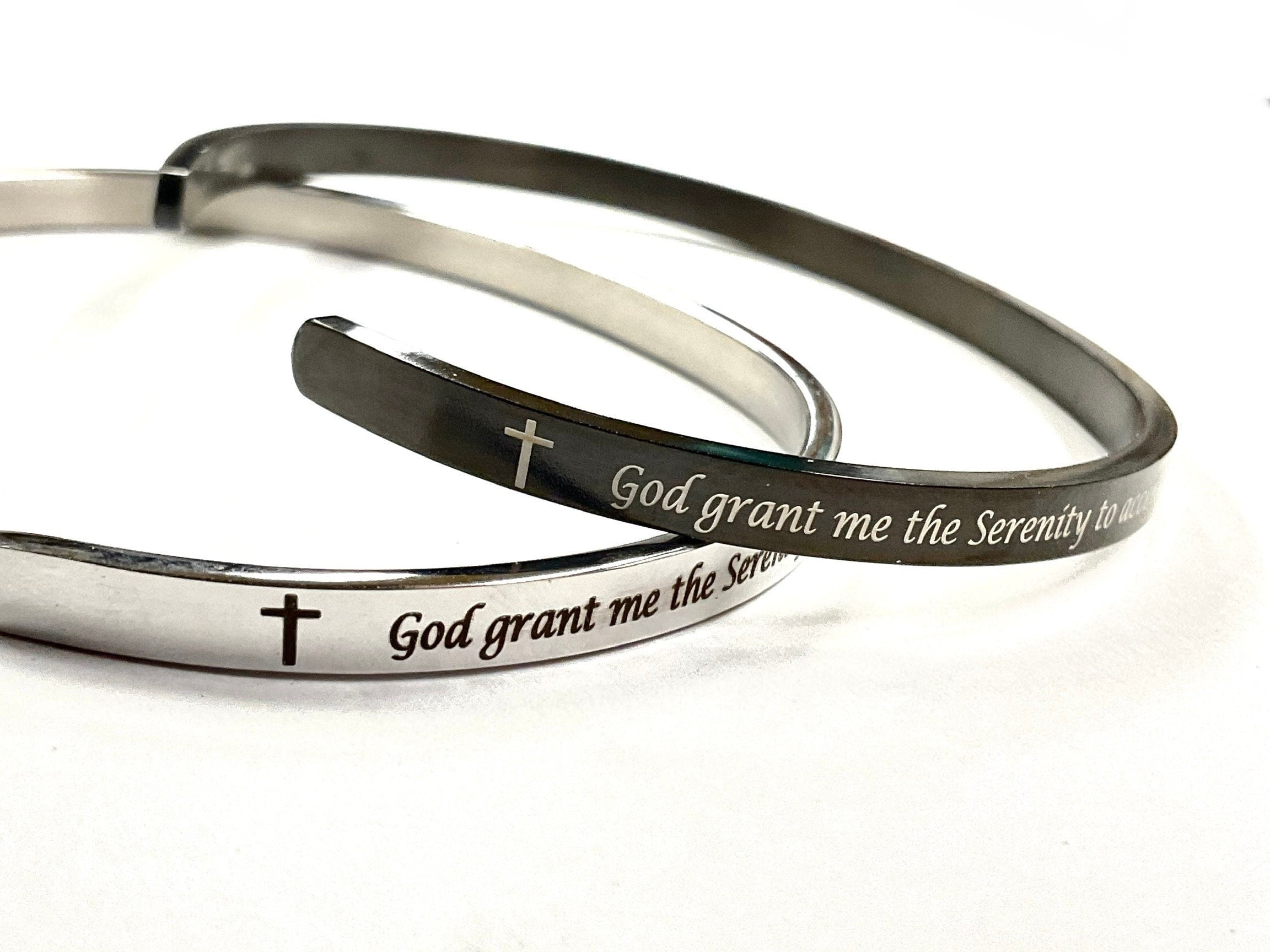 Silver and black stainless steel cuff bracelet with engraved serenity prayer text and cross