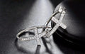 Silver cross hoop earrings with clear stone pavé cross and open hoop frame