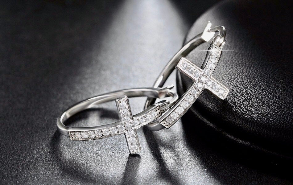 Silver cross hoop earrings with clear stone pavé cross and open hoop frame