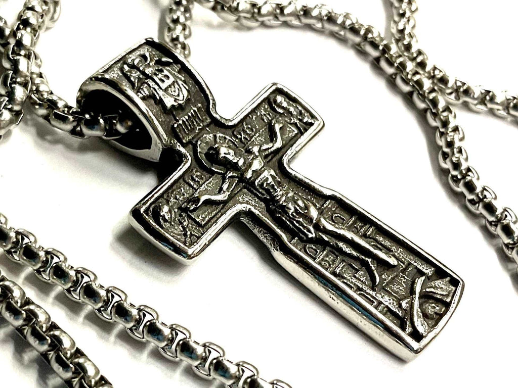 Silver crucifix cross pendant necklace with detailed metal figure and chain links
