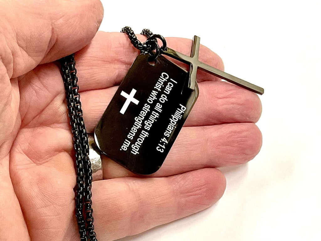 Black dog tag cross necklace close-up: stainless steel cross and Philippians 4:13