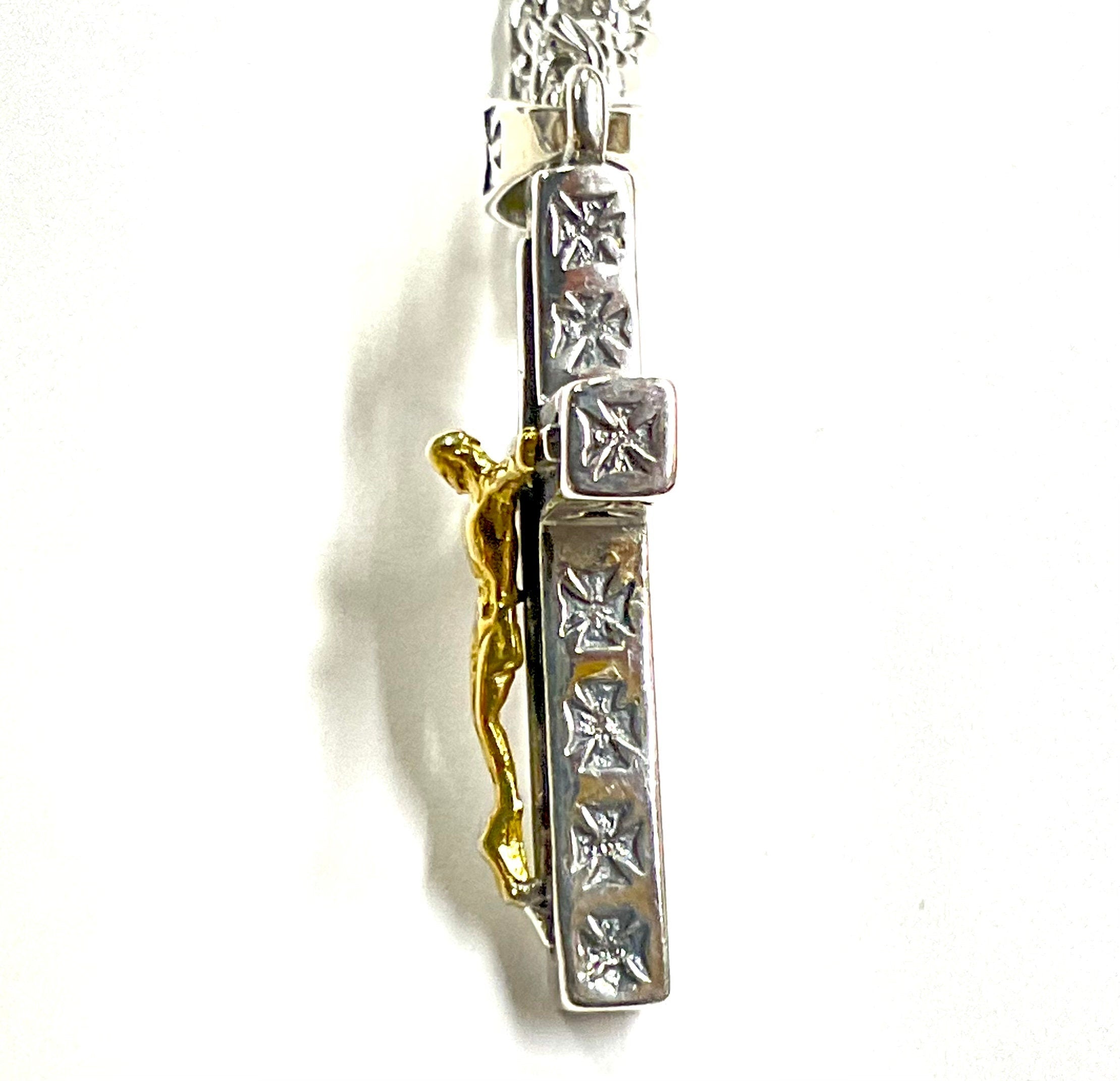 Two-tone crucifix cross pendant side view with gold-tone figure on silver chain