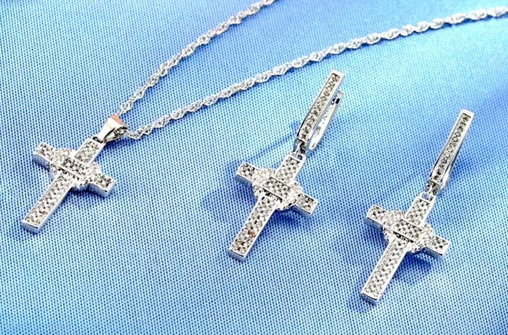 Sterling silver zircon cross pendant and earrings with link chain on blue fabric