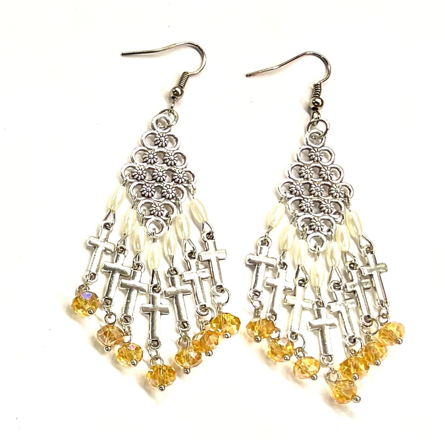 Silver-tone filigree cross dangle earrings with pearl beads and dark yellow drops