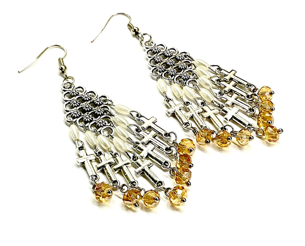 Silver-tone cross dangle earrings with pearl beads and dark yellow glass tassels