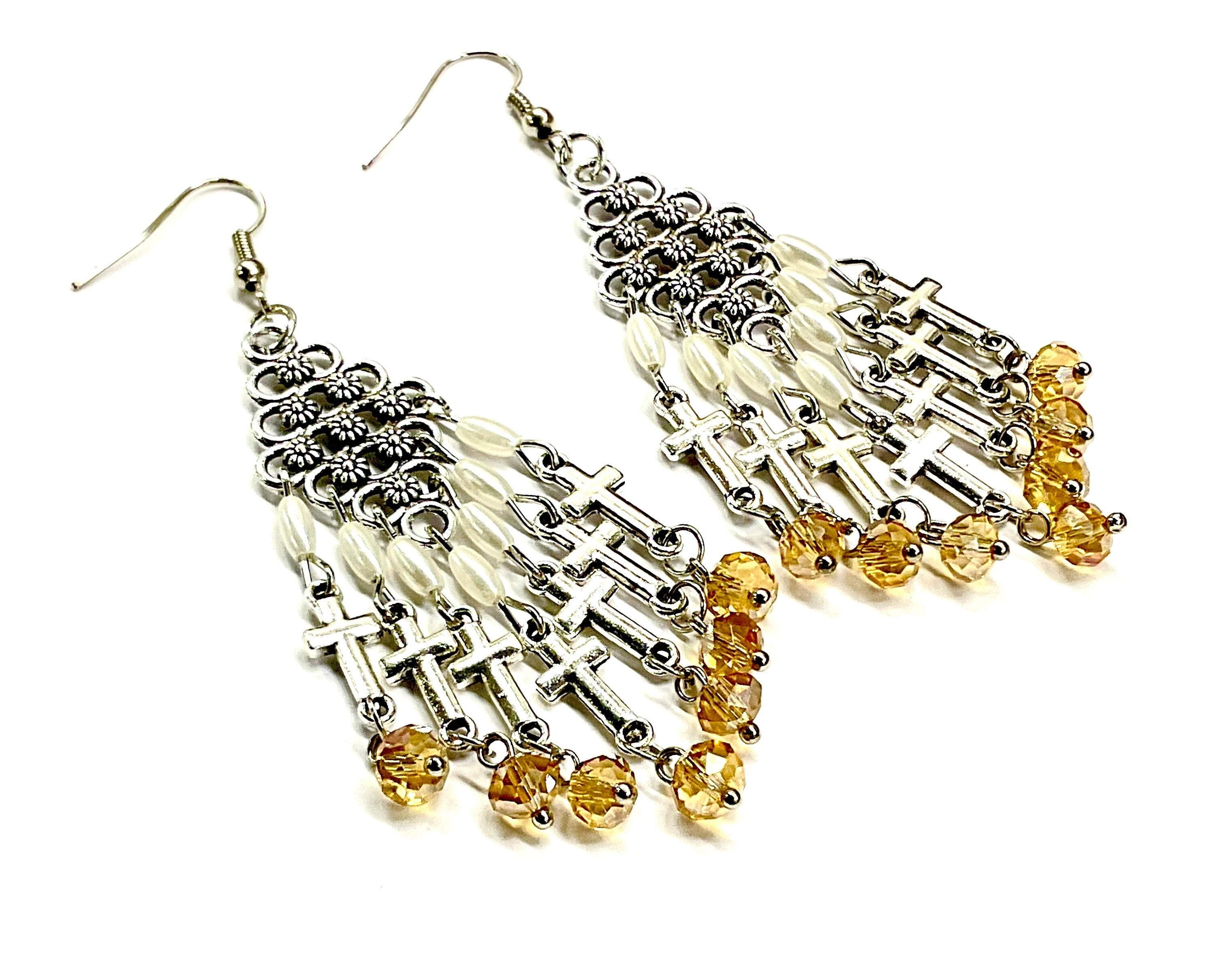 Silver-tone cross dangle earrings with pearl beads and dark yellow glass tassels
