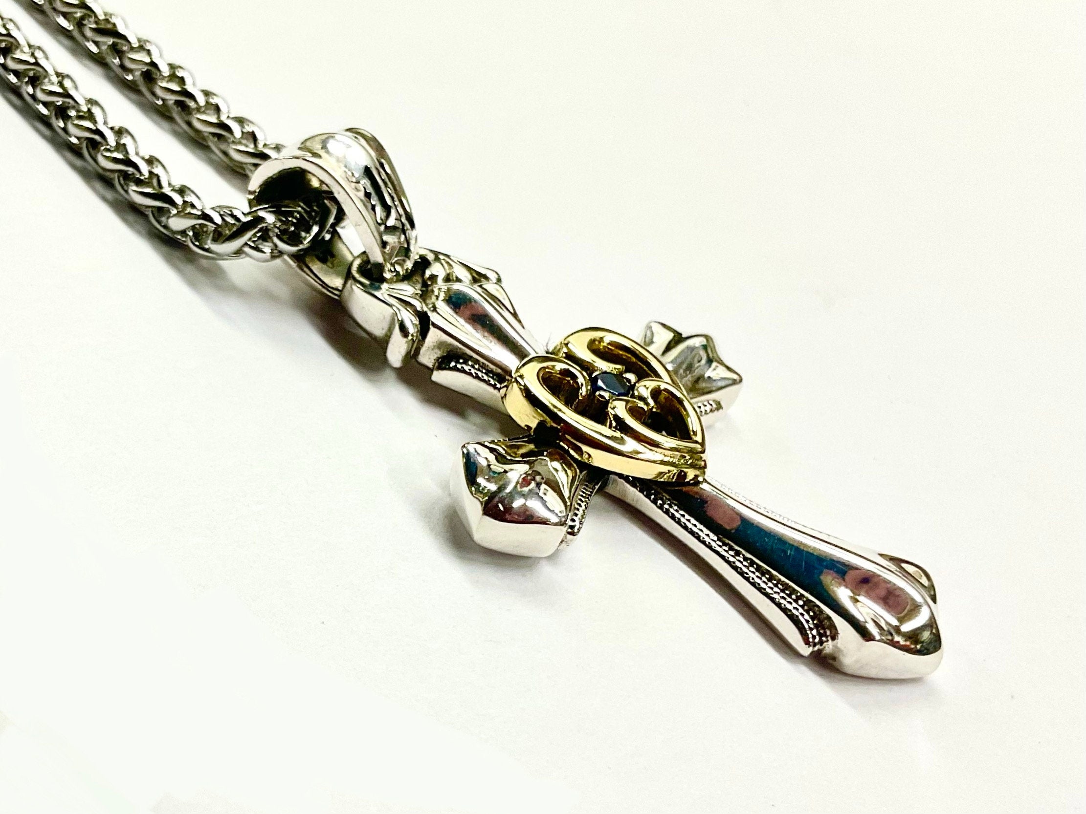 Cross pendant necklace with open heart in gold and blue zircon, sterling silver