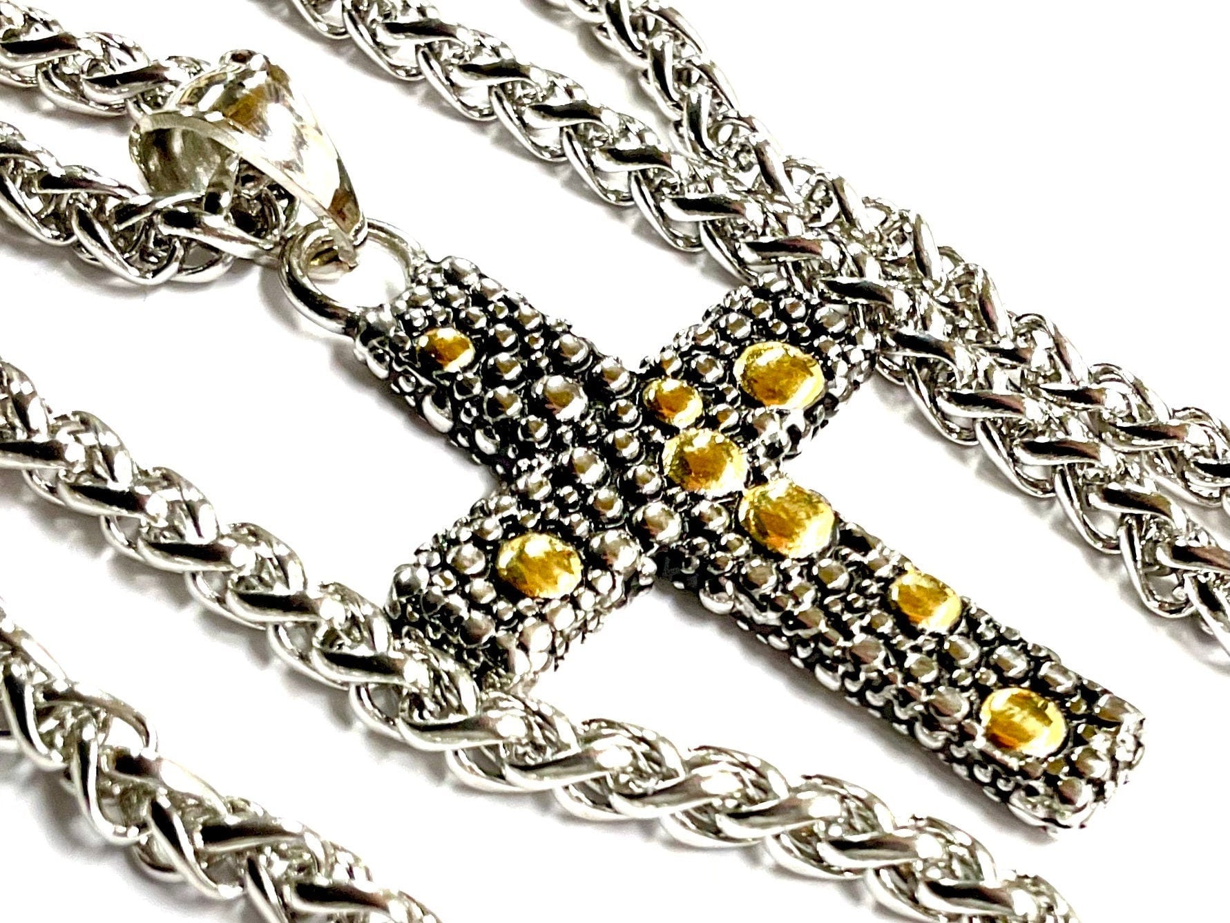 Stainless steel crucifix pendant with yellow gem-like stones, heavy chain.