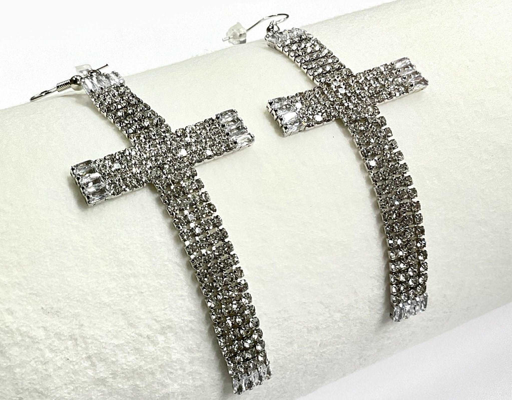 Rhinestone cross dangle earrings, close-up of long cross with square end studs