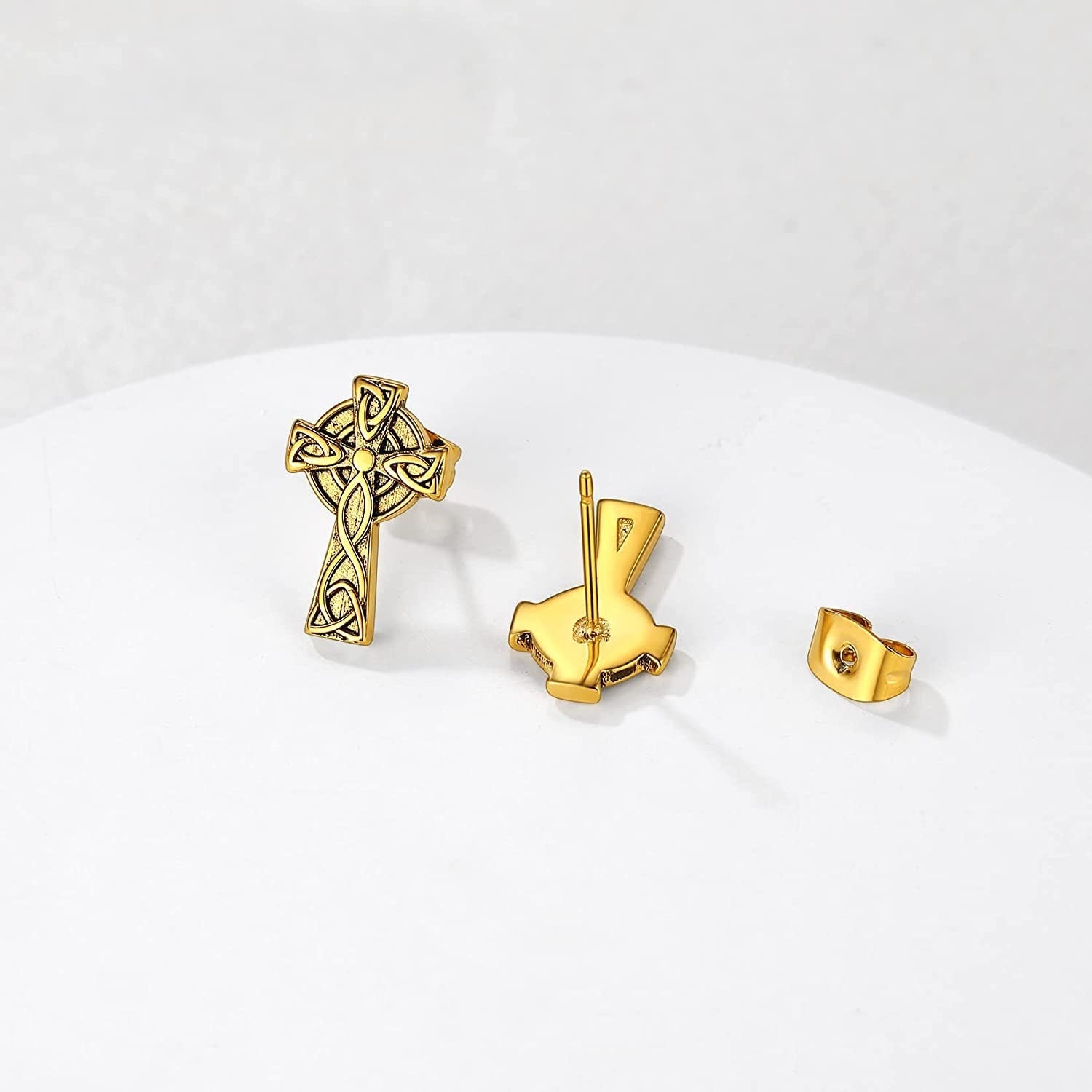 Gold-tone Celtic knot cross stud earrings with post backs, shown as a set