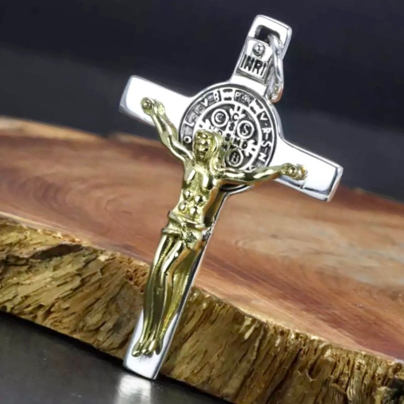 Silver and gold-tone crucifix pendant with Jesus figure and circular medallion