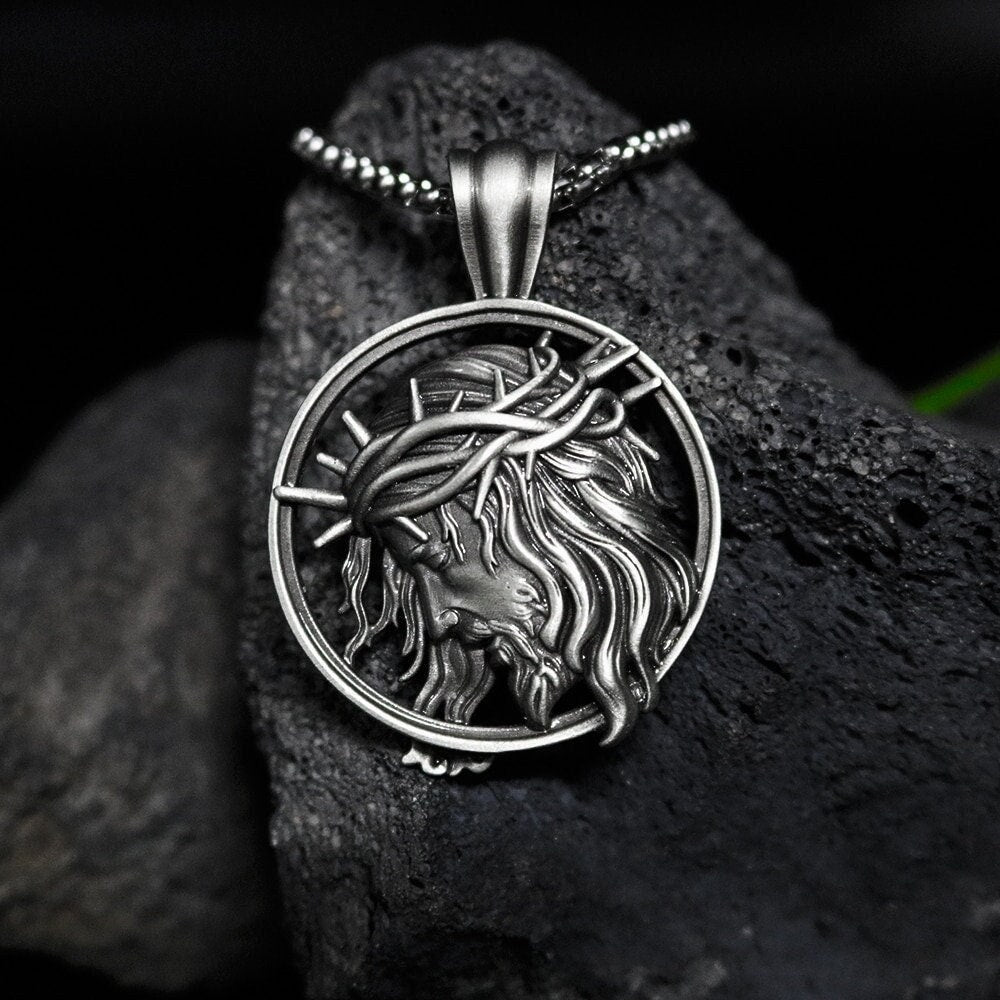 Religious pendant necklace with circular antiqued Jesus portrait pendant on chain.