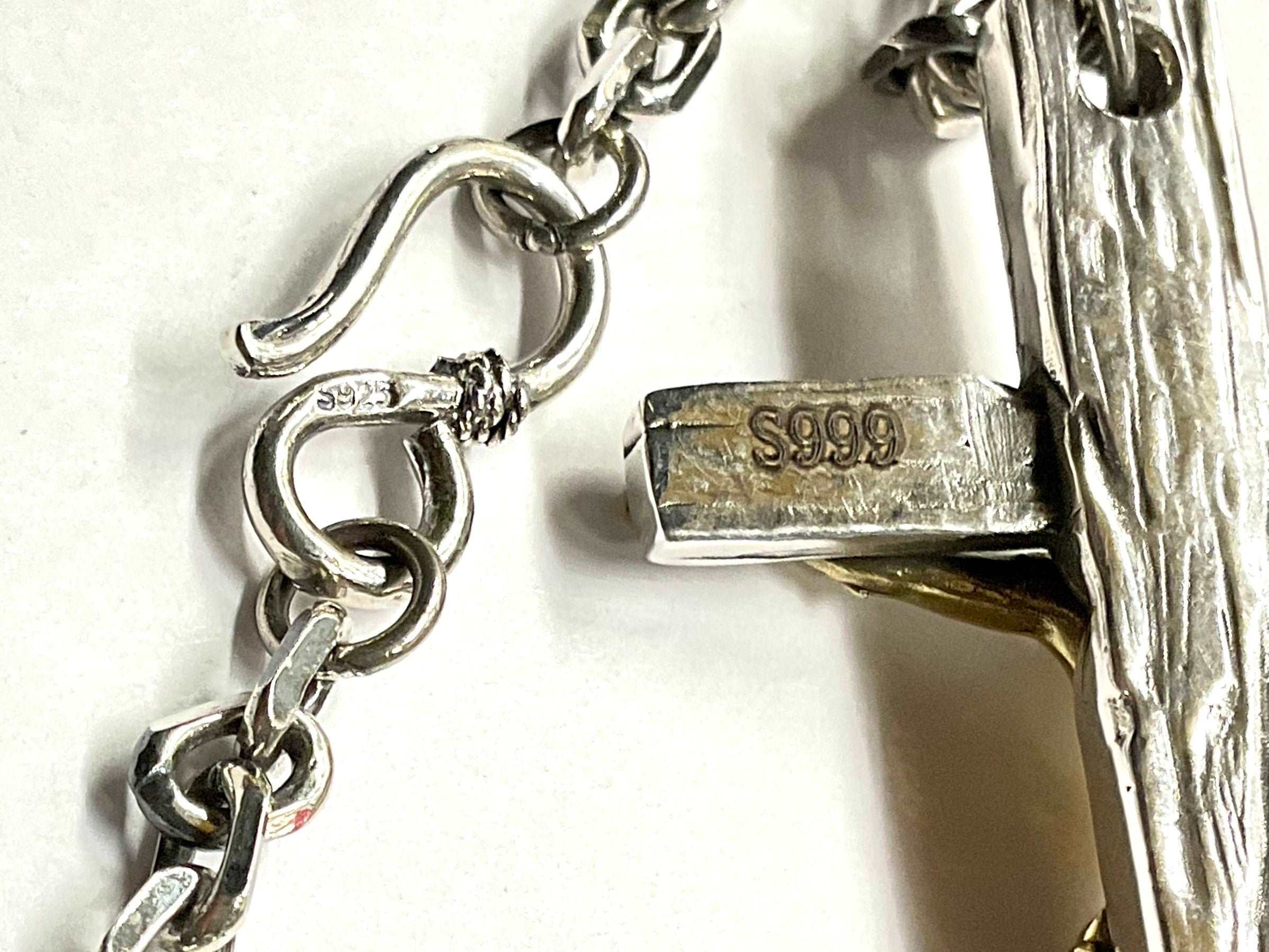 Sterling silver chain clasp stamped S925 and attached crucifix pendant