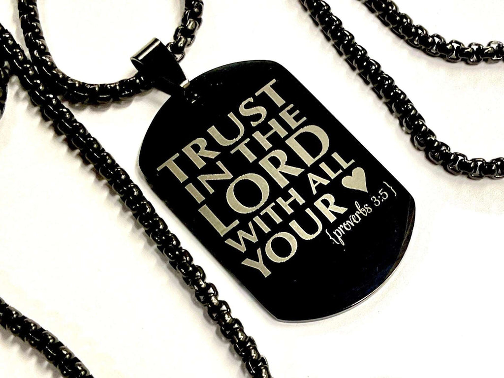 Black dog tag necklace pendant on black chain, engraved scripture text.