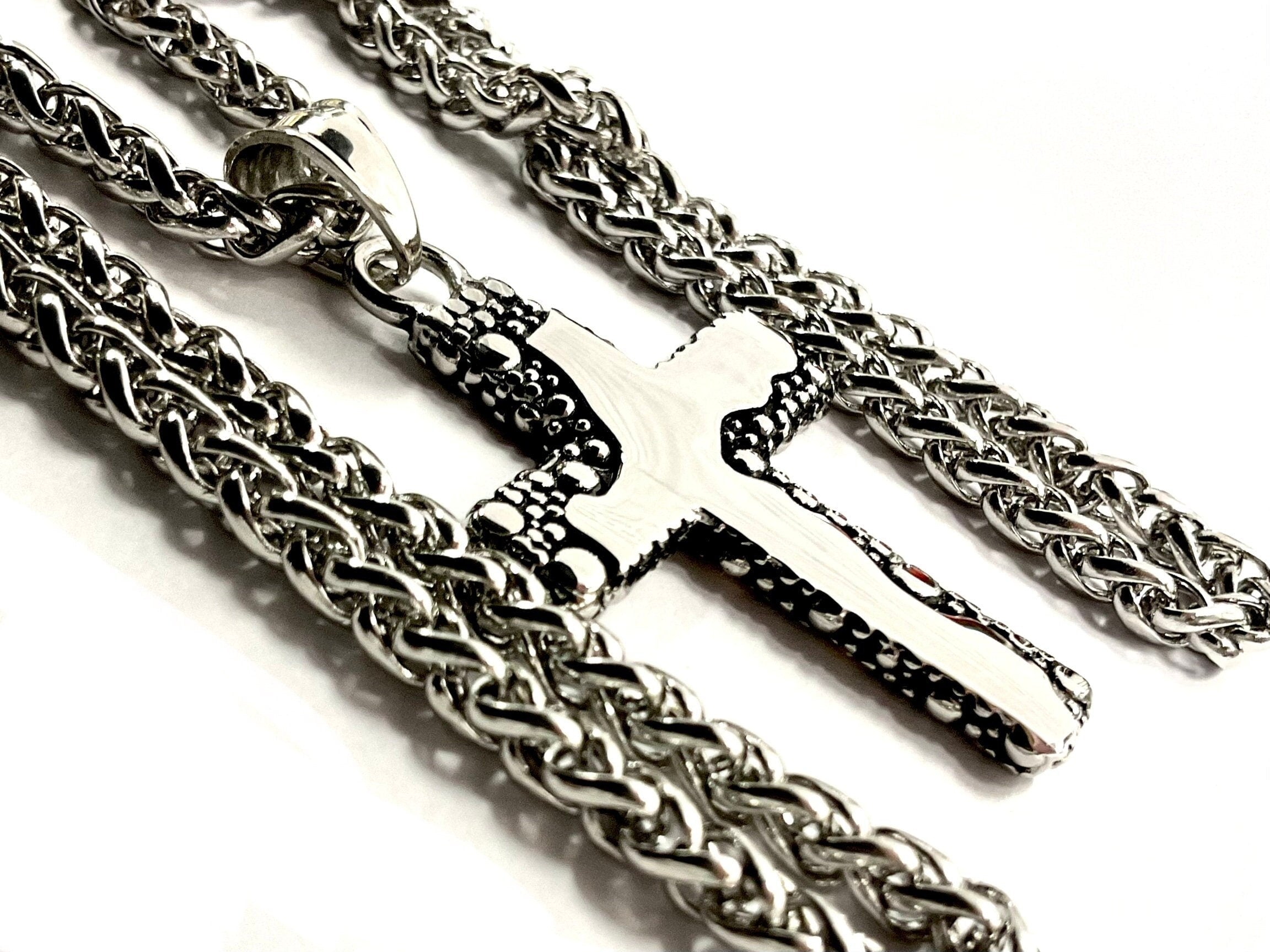 Stainless steel crucifix pendant on heavy chain necklace, textured details.