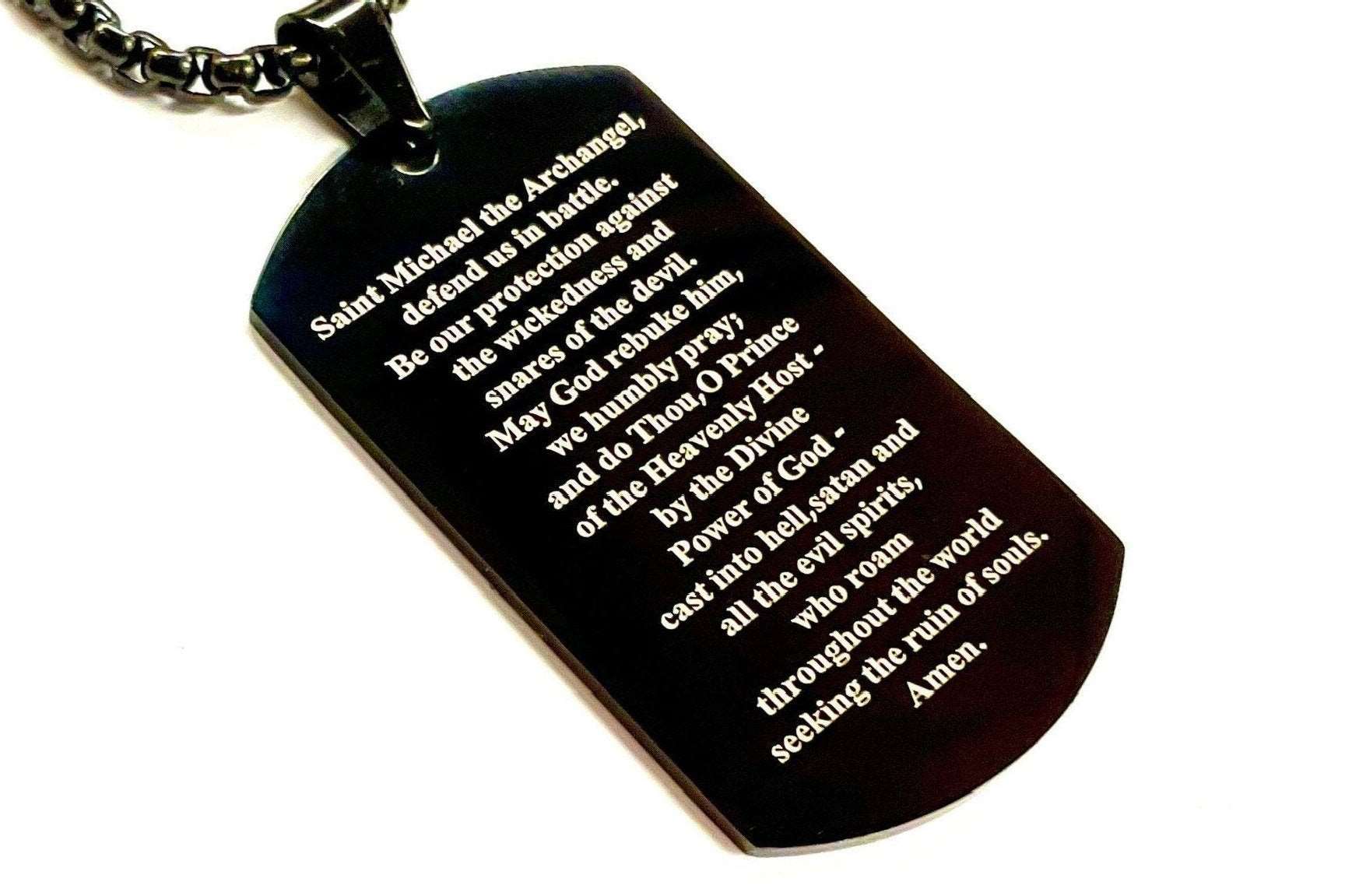 Black dog tag necklace with engraved Saint Michael prayer and link chain, front angled.