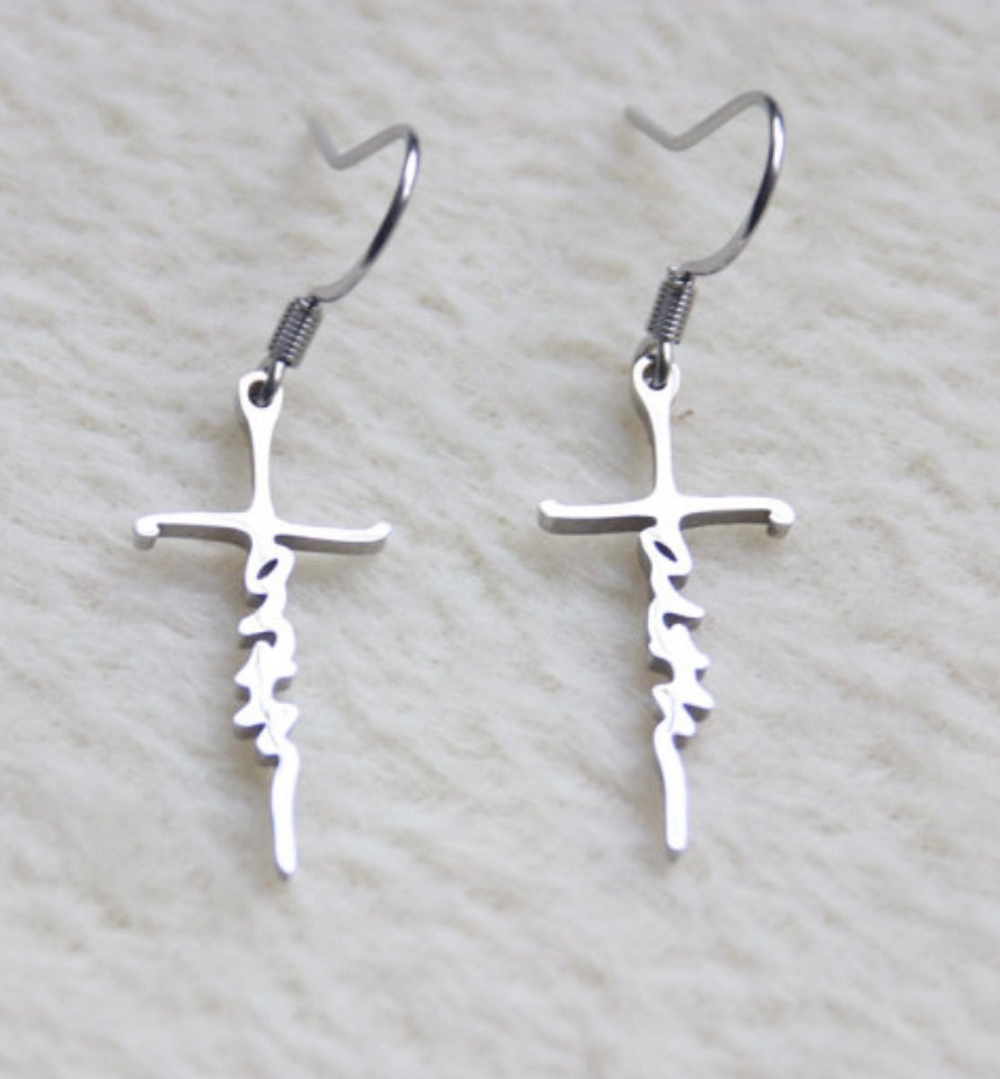Silver cross dangle earrings with script cutout on vertical bar