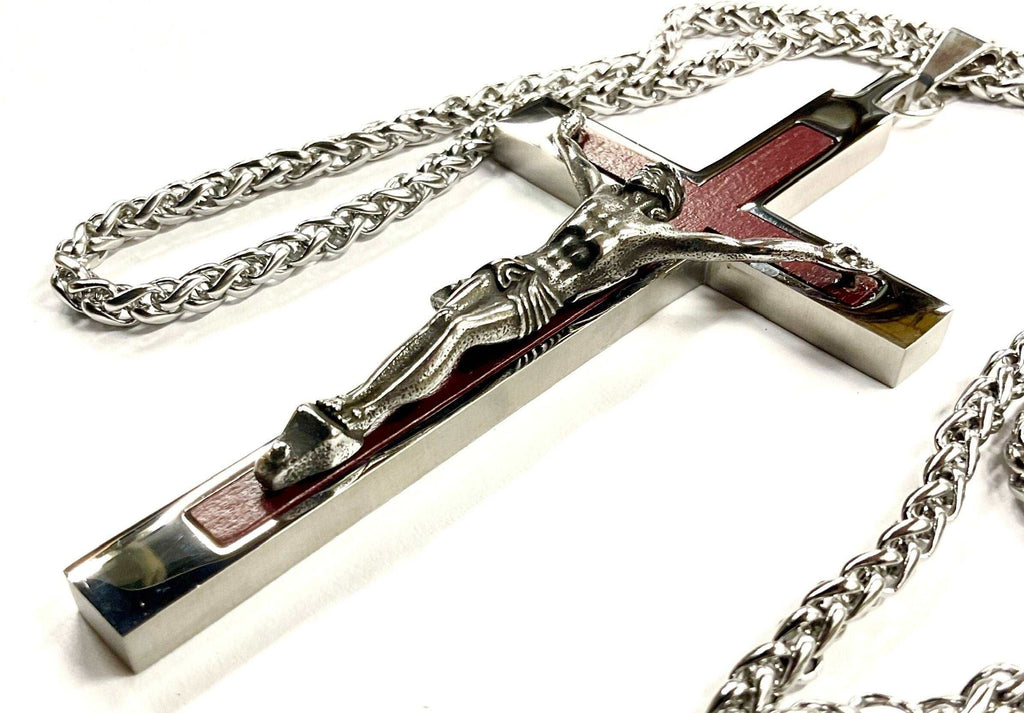 Crucifix cross pendant necklace in silver-tone metal with red inlay, on chain