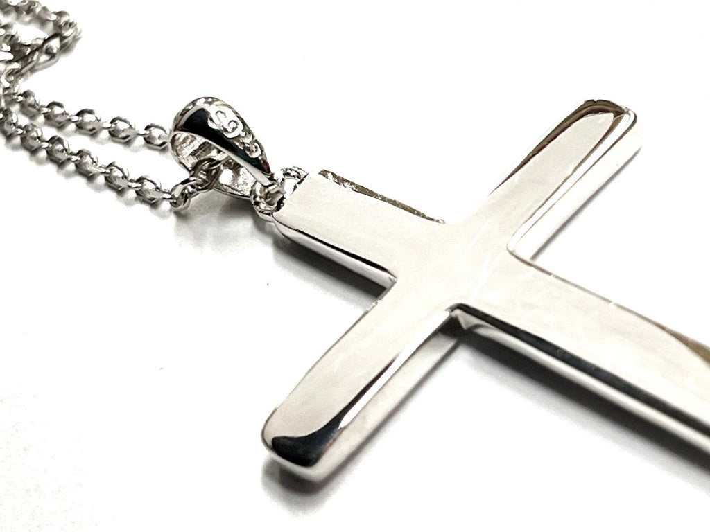 Sterling silver cross pendant necklace with bail and chain on white background