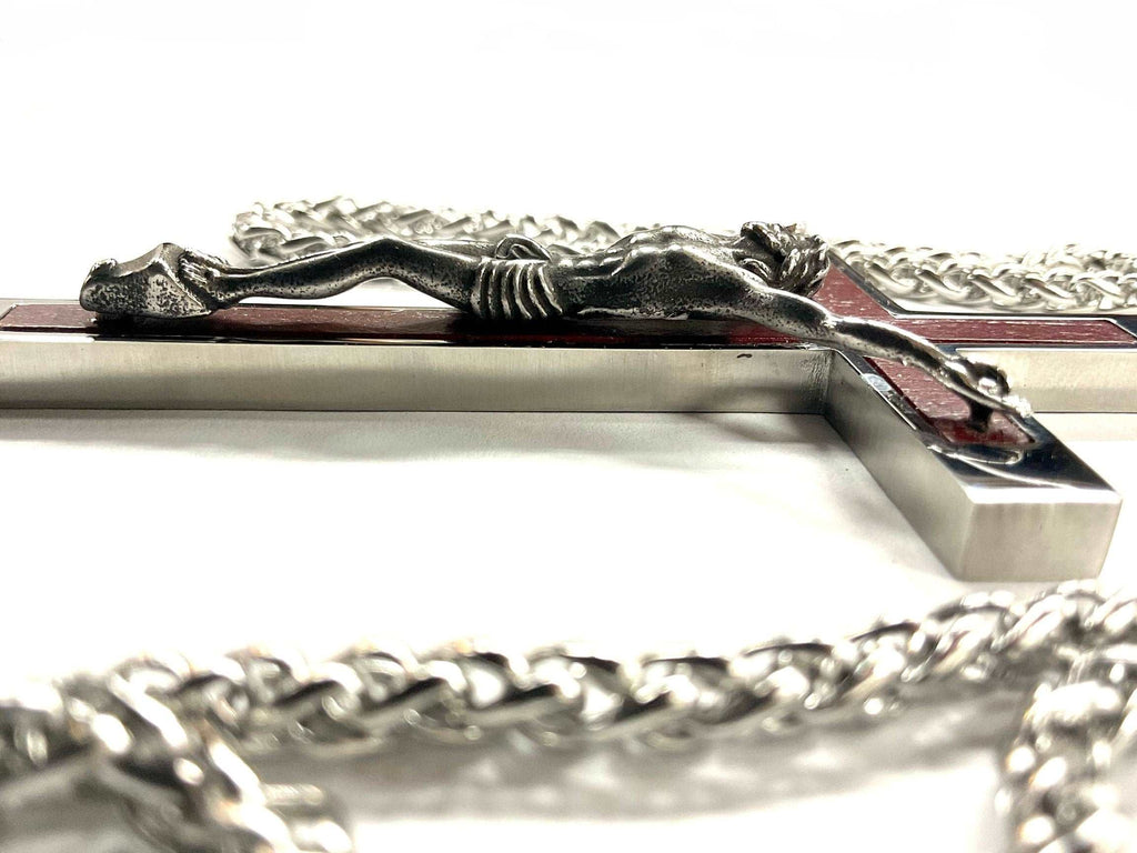 Silver-tone crucifix cross pendant with red inlay, hanging on chain