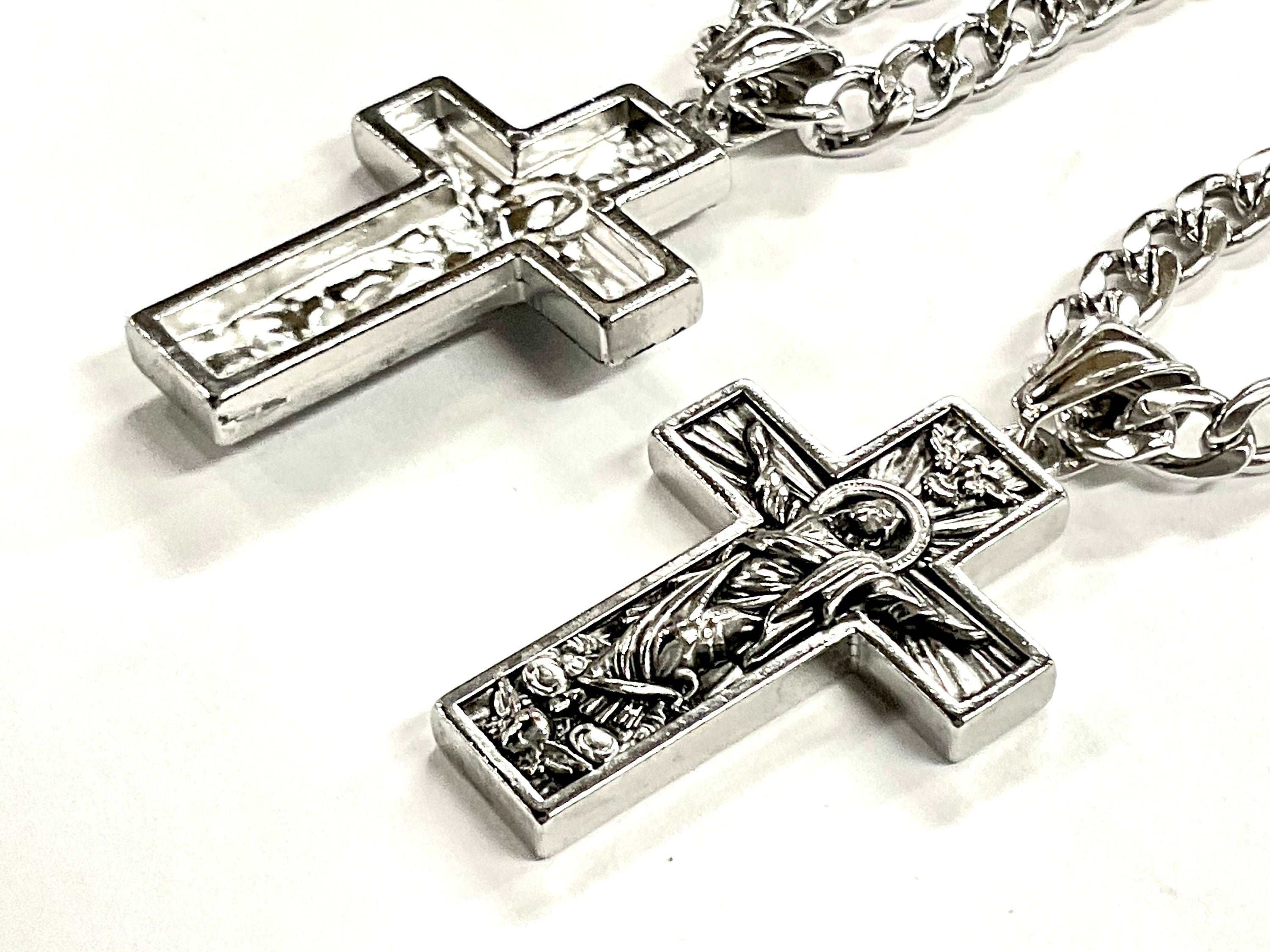 Silver-tone crucifix pendant necklace on box chain, side view with detailed Jesus panel