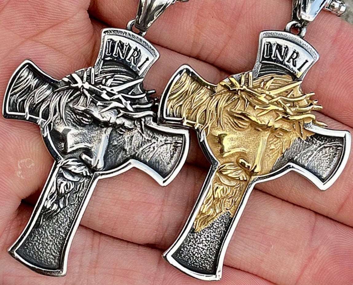 Two crucifix necklace pendants, silver and gold with INRI plaque and thorns