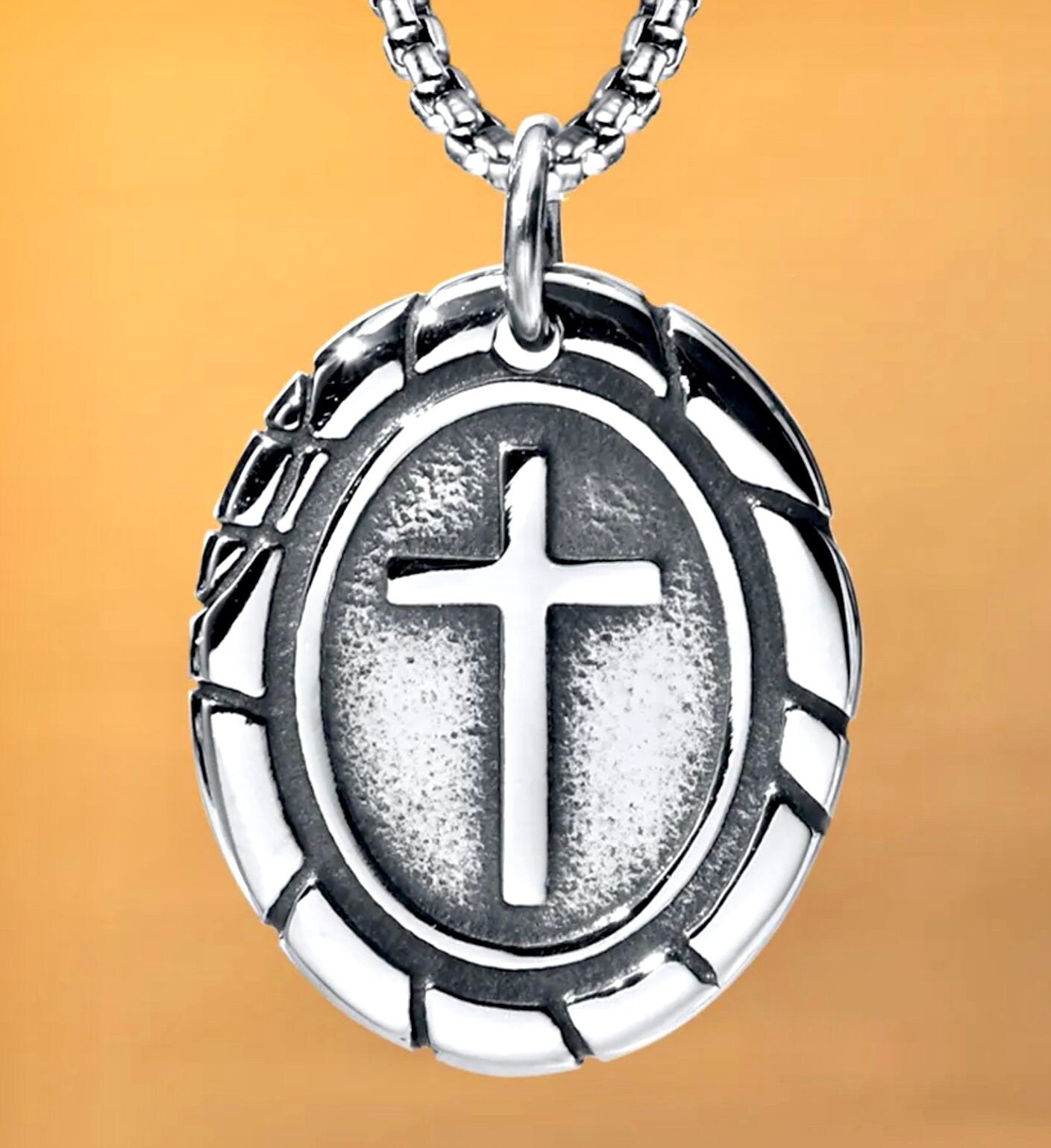 Large silver-tone oval cross pendant on box chain with ridged outer frame