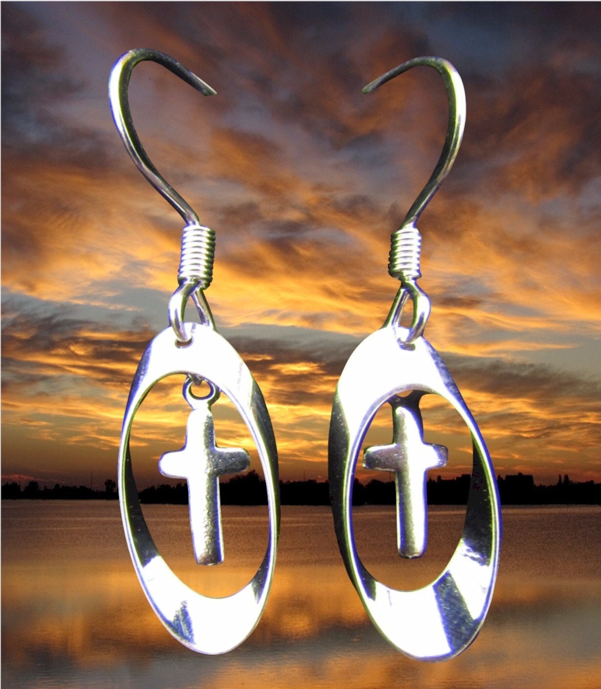 Silver oval drop earrings with cross charms and spiral hook tops