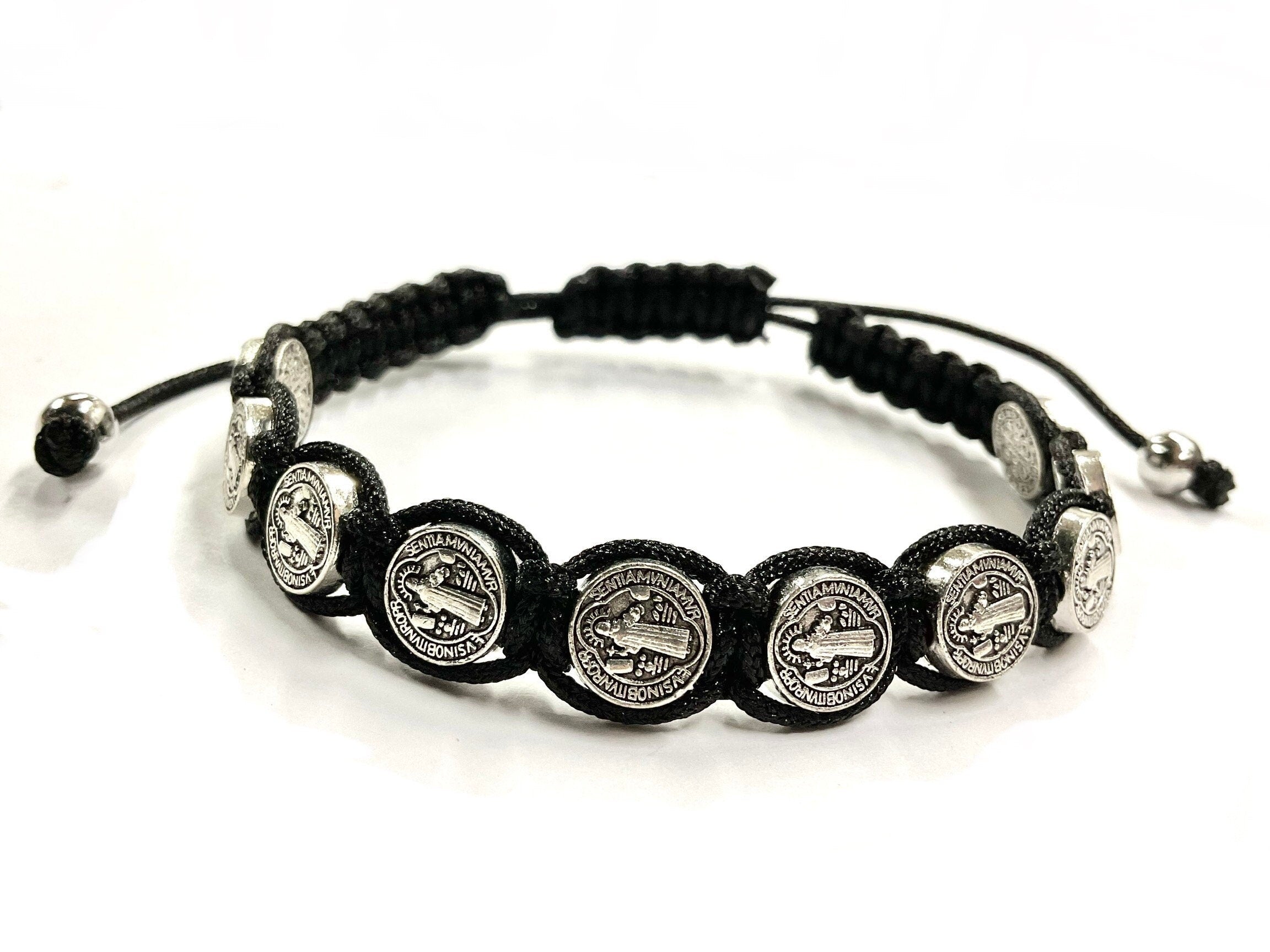 Black woven string bracelet with round silver-tone coin medallions and pull ties