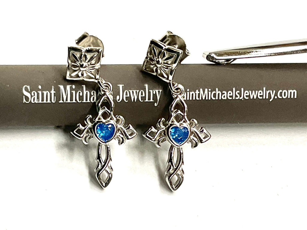 Sterling silver cross dangle earrings with blue zircon stones and ornate detailing