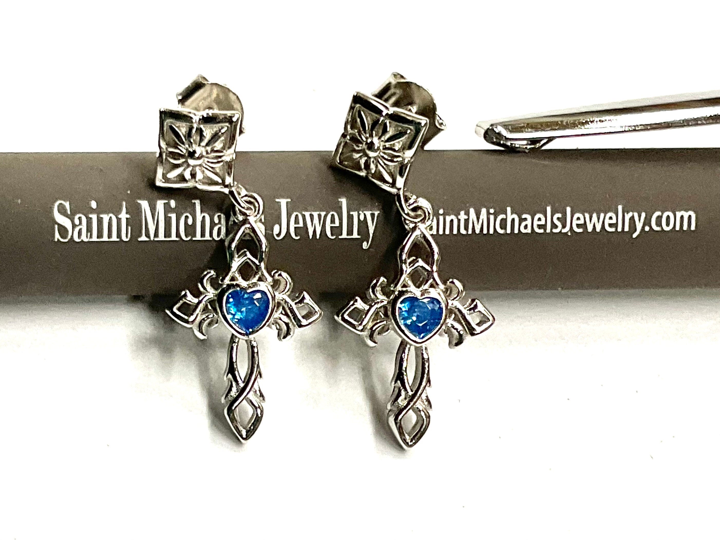 Sterling silver cross dangle earrings with blue zircon stones and ornate detailing