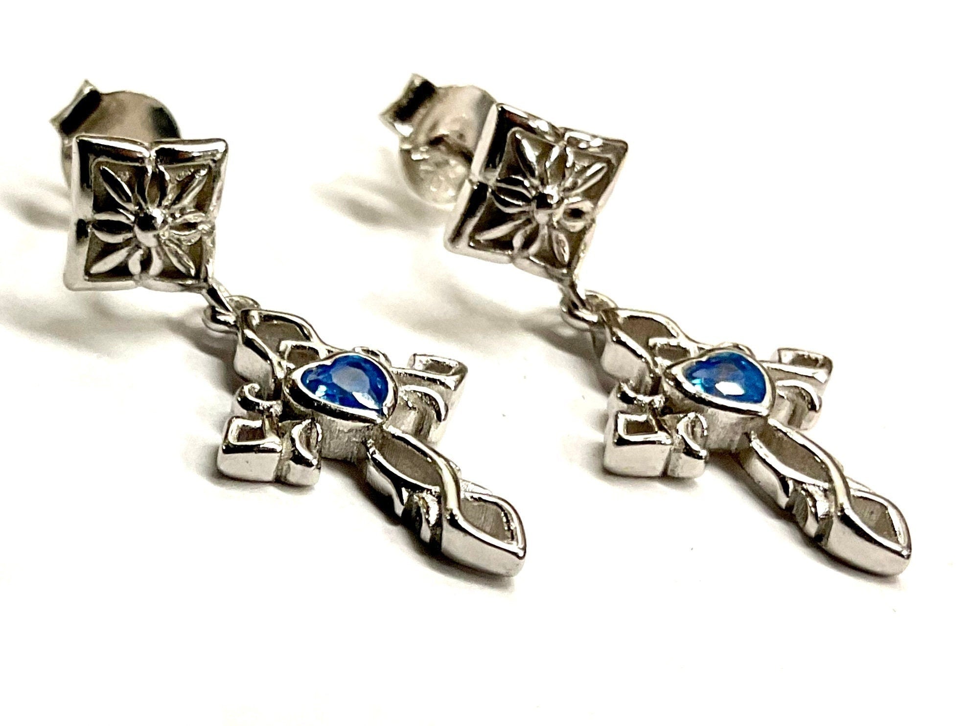 Sterling silver earrings with blue zircon cross charms and sacred heart motifs