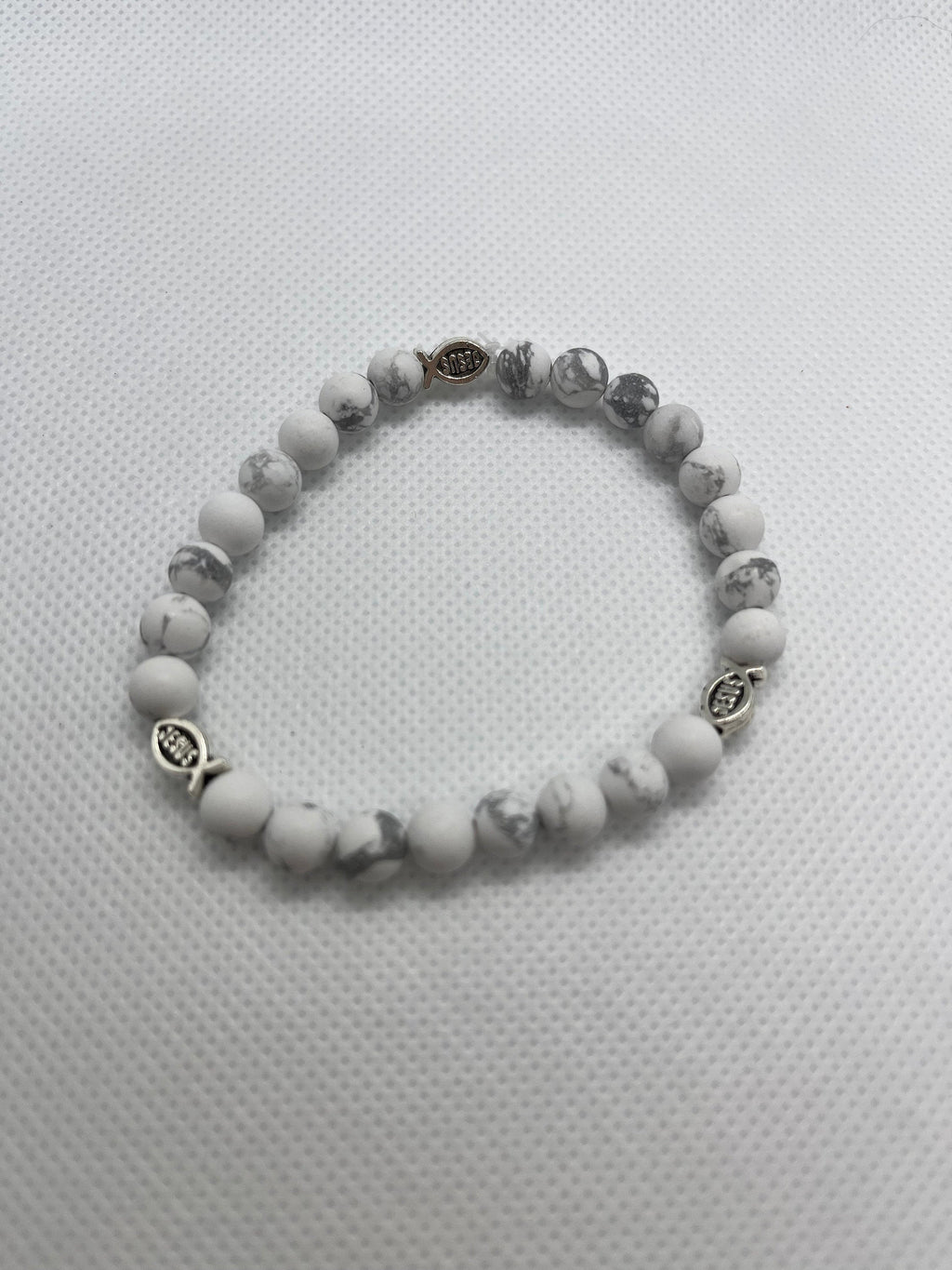 White marble beaded bracelet with fish charm and dark metal spacer beads
