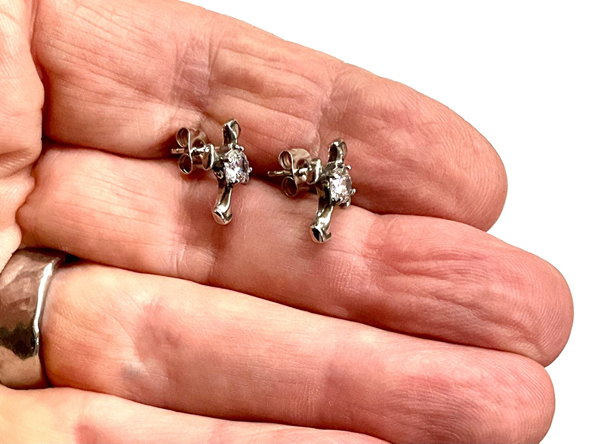 Silver cross stud earrings on hand, round zircon stones with back post hardware