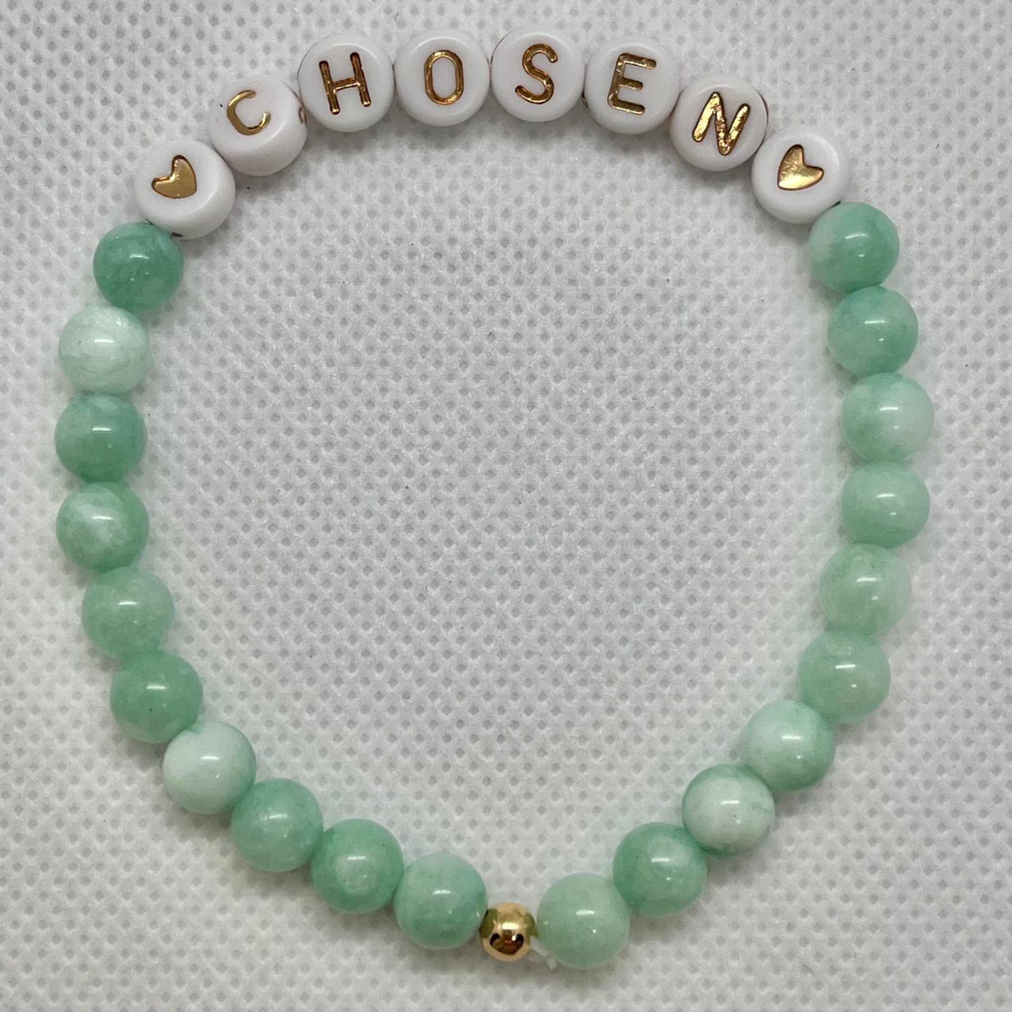 Jade green and white bead bracelet spelling CHOSEN with gold clasp bead