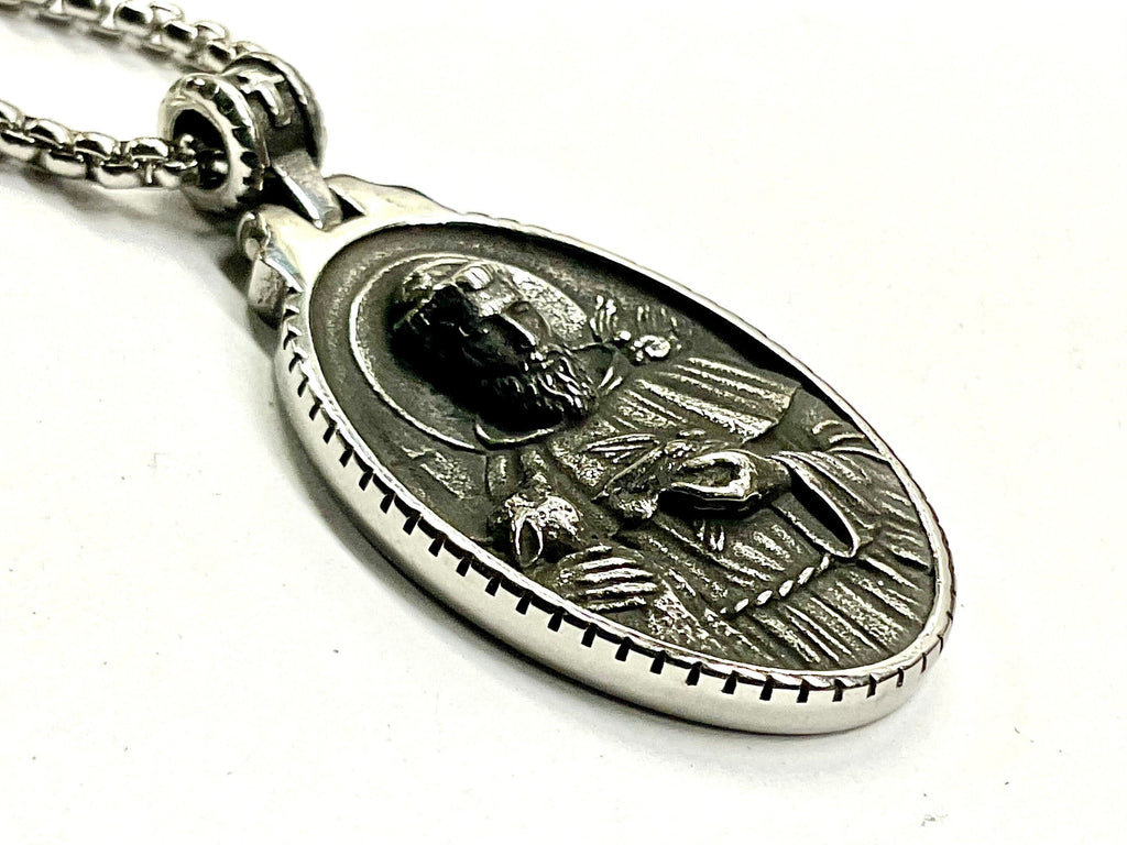 Oval metal medal pendant on link chain with relief figure
