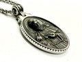Oval metal medal pendant on link chain with relief figure
